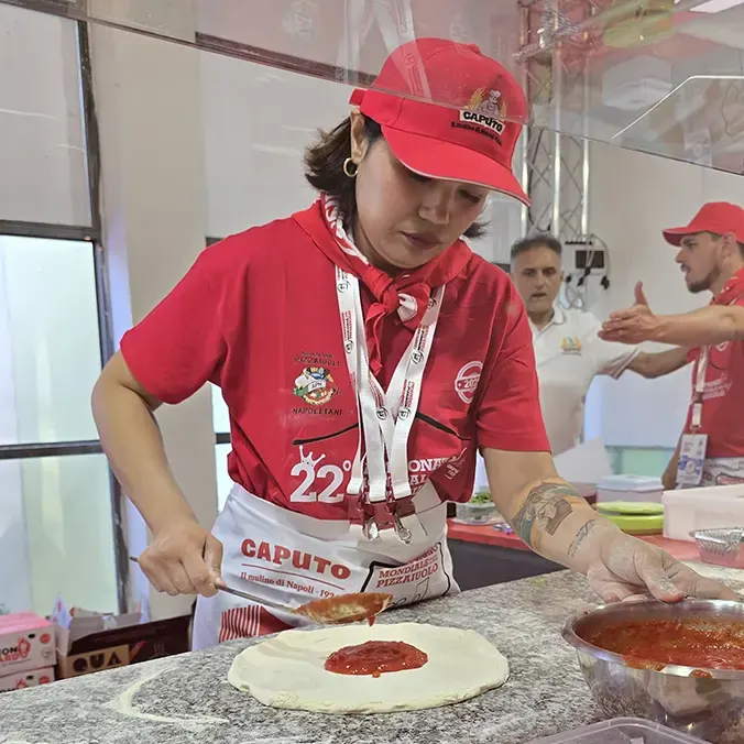 Kasira working the dough at Caputo Cup 2025 Kasira making Neapolitan pizza